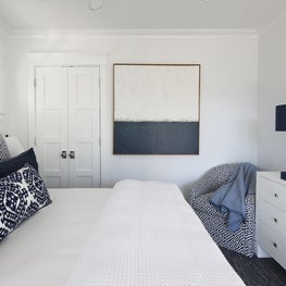 Navy and white bedroom in a beach house