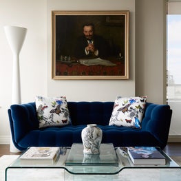 Chic eclectic living room with glass coffee table