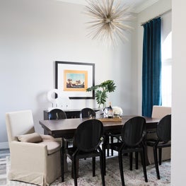 Rustic modern dining room with starburst chandelier and modern chairs