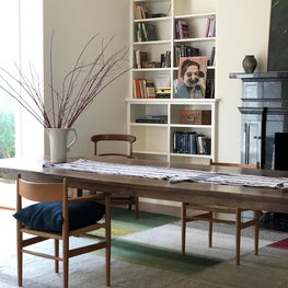 Dining room with a 19th-century 12-foot long walnut dining table on a watercolor designed rug