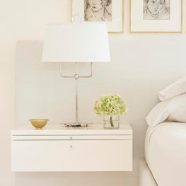 A custom wall mounted nightstand incorporated into the master headboard.