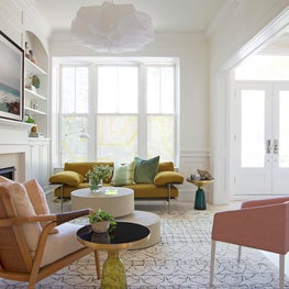 Contemporary soft muted sitting room with modern furnishings and white walls