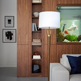 These grand fish tanks act as a partition between the communal space and more secluded library.