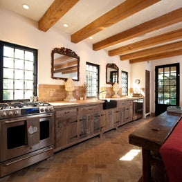 Kitchen with Reclaimed Beams, Barn Board Cabinets and Herringbone Stone Floor