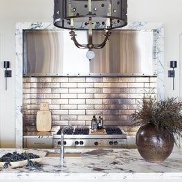 Contemporary kitchen with marble and metallic accents