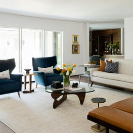 Portfolio: Mid-century modern living room with blue chairs and a tufted sofa