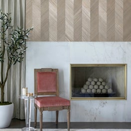 Portfolio: Maya Romanoff wood veneer and a marble fireplace with vintage chair in blush.
