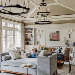 Neutral beige cream living room sunburst vaulted ceiling two-tier chandelier