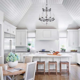 White Kitchen, David Iatesta Lighting, Hardwood Floors, Neutral Palette, Wood Stools, Stainless Steel Refigerator - Ravinia Residence Project