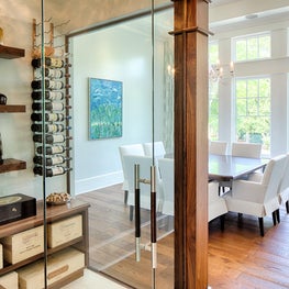 A glassed-in wine room is a focal point showcasing a collection of fine wine