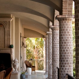 Loggia with Round Tapered Brick Columns, Plaster Groin Vaults and Stone Mantel 