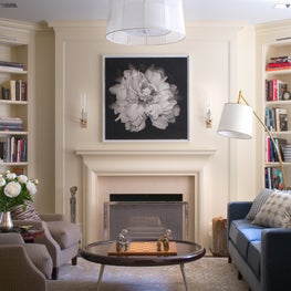 Classic NYC apartment Living room with fireplace and black and white artwork 