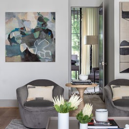 Portfolio: Modern living room with grey swivel chairs and Terrell James abstract art