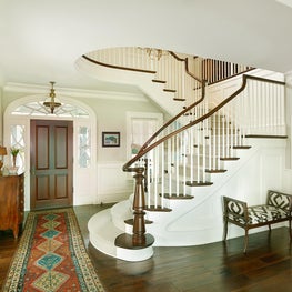 Front Entry with Curved Stair with Turned Walnut Newel and Handrail