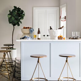 Contemporary custom bar with painted millwork and marble countertop