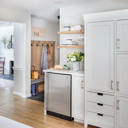Dry bar w/ floating shelves, custom pantry cabinet, oak mudroom w/ slate floor 