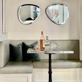72nd Street Breakfast Nook with Upholstered Banquette, Vintage French Cafe Table and Ray Ban Mirror