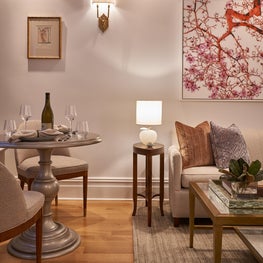 This small space apartment design makes transitional rooms cozy and warm