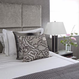 Relaxing glamorous bedroom using textures in wallcovering and soft furnishings 