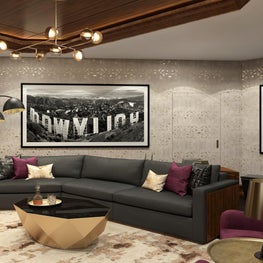 The curved grey upholstered sofa is complemented by the black and white photo.