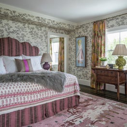 Bedroom with Upholstered Headboard, Pink Rug and Textured Throw