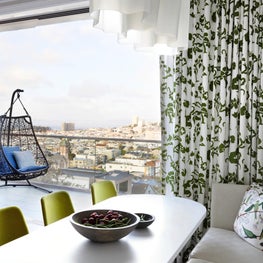 A sleek, whimsical kitchen with a view