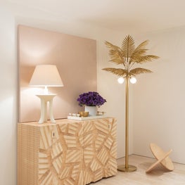Cool beachy summer vibes / This brutalist console sits perfectly along the cool palm tree floor lamp of this chic Miami Beach entrance hallway.
