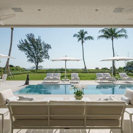 An oceanfront loggia with minimalist pool in a new modern beach house