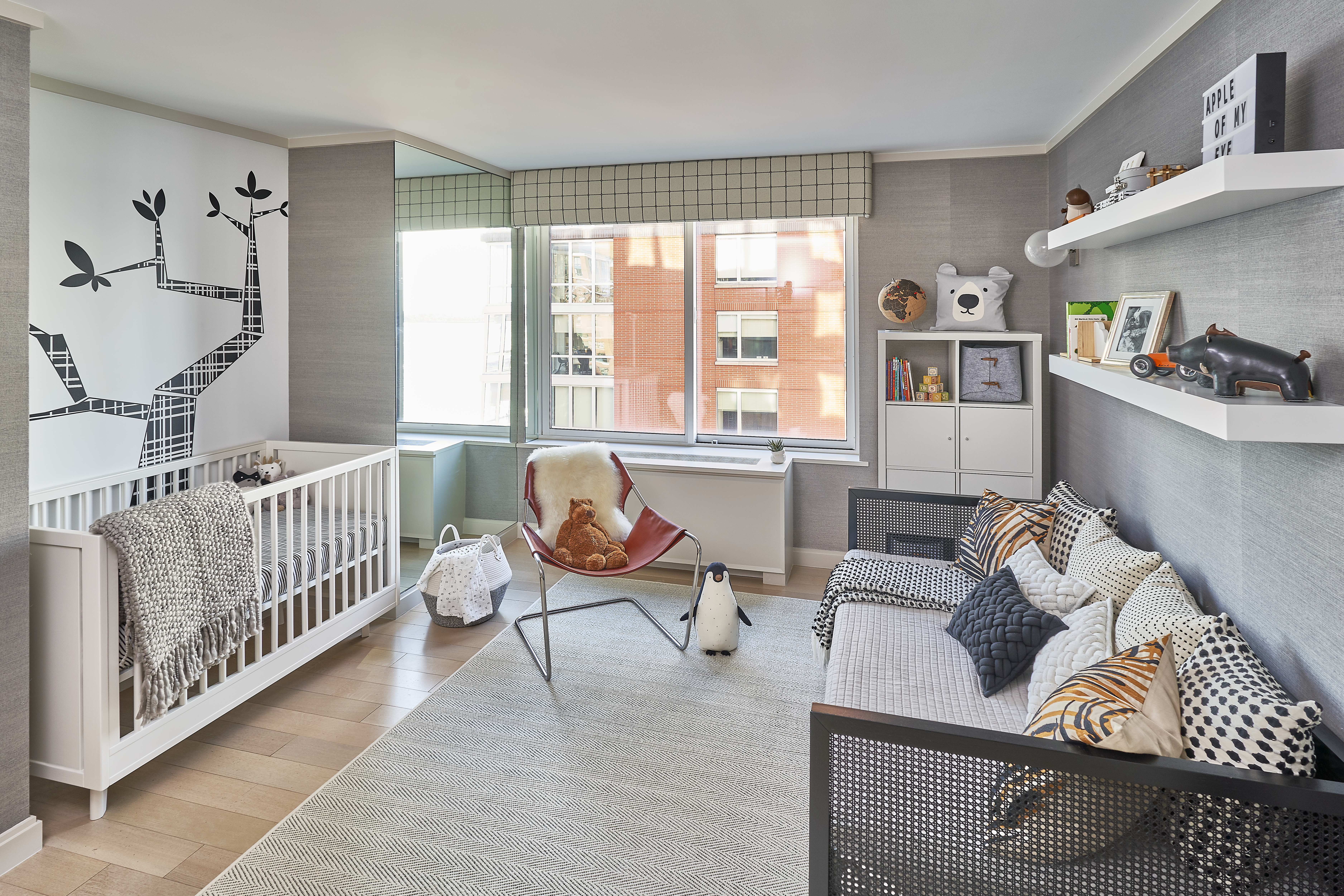 Black and white nursery in Tribeca complete with grasscloth wallpaper and decal