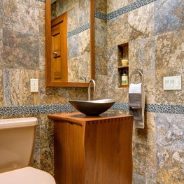 Tile and stone composition: custom Asian vanity and metal vessel sink