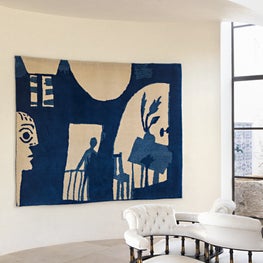 The entry of this Modern Mediterranean home includes this woven Picasso image