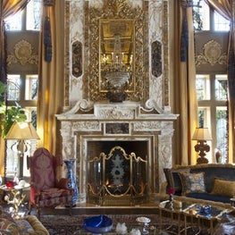 An elaborate custom fireplace surround and overmantle complete this dramatic remodel of a Dallas, TX great room.