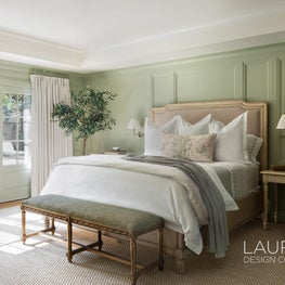 Soft greens and architectural charm abound in this refreshed primary bedroom.