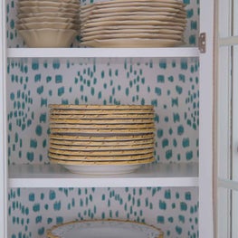 Everyday Dinnerware in Glass Paned Kitchen Cabinets with Wallpaper