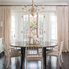 Transitional dining room with round table and bobbin chairs