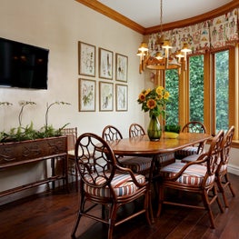 This breakfast nook off the kitchen has hardwood flooring and wood trim.