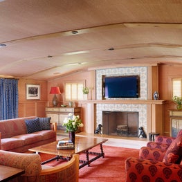 Natural grasscloth wallcovering creates a warm backdrop for bold shades of red 