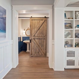 Detailed millwork, built in shelving and barndoor