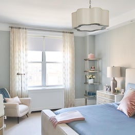 Clean and classic bedroom with soft blue accent bedding