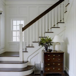 A simple stair case with wall paneling