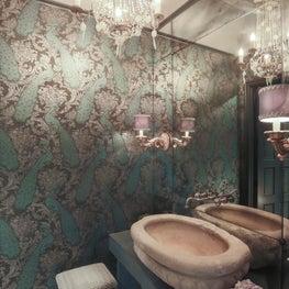 Formal powder- reclaimed stone sink, metallic wallpaper & antique mirrored wall