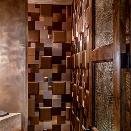 Concealing a small storage recess behind the padded wall is an ingenious way to store supplies 