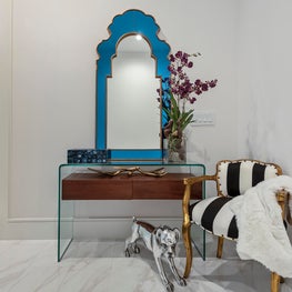 Contemporary entry console, blue hand carved queen anne mirror & dog scultpure.