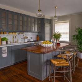 Kitchen Island with Grey Cabinetry, Hard Wood Counter and Woven Seagrass Stools