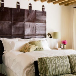 Leather headboard with giant nails, vintage beams