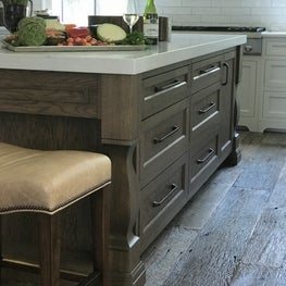 Custom kitchen island with reclaimed flooring