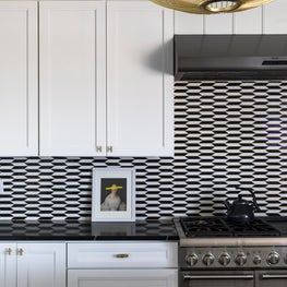 Custom cabinetry with marble and brass backsplash 