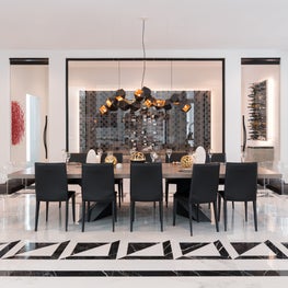 Portfolio: The Friar Tuck dining area with sleek black chairs and statement lighting.