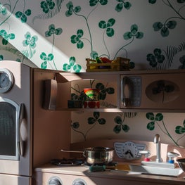 Play Kitchen & Wallpaper Detail in Eclectic Girl's Bedroom with Colorful Power Clashing Patterns and Collected Vintage