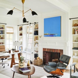 Blue and white mid century library with Eames chair